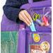 Close up image of the tote holding notions like thread spools and scissors for scale with someone reaching from behind the tote to pull out a rotary cutter.