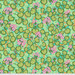 Fabric featuring vibrant pink geraniums climbing along golden yellow vines with bright green leaves over a teal and green background