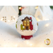 Photo of a wool felt snow globe featuring a small house in a snowy scene, surrounded by white Christmas and winter decor.