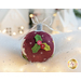 Photo of a wool felt ornament featuring a small bunch of holly leaves and berries, surrounded by white Christmas and winter decor.