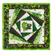 Photo of the finished wall hanging featuring offset squares in shades of green with a shamrock and top hat in the center, isolated on a white background.