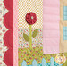 Colorful quilt featuring a flower adorned with a button against floral and polka dotted fabrics.