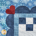 A close-up of a quilt featuring a blue background with white snowflakes. The quilt has a dark blue scalloped border with a small red heart positioned in the upper left corner. The center of the quilt includes a patchwork design with various blue and white fabric squares.