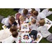 A group of children gathered around a colorful quilt spread on grass