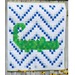 Quilt featuring a green alligator design on a white and blue zigzag pattern background.