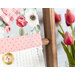 Close up photo of the top of a hanging towel on a small ladder leaning against a wall with a cutting board in the background