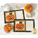 A top down shot of the completed mats staged on a white table with a teapot, teacups, pumpkin shaped cookies, and a coordinating decorative pumpkin.