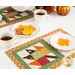 A closer look at the mats in action, showing a plate of colorful, leaf shaped cookies and cups of tea.