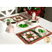 A shot of a white table set with the placemats, each holding a white plate with a coordinating tree shaped cookie. The table is set with coordinating Christmas decor and full cups of tea.