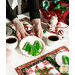 A closer shot of the two mats in action, with a model holding up a white plate with tree-shaped cookies.