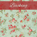 A light teal blue fabric with tossed red florals and green leaves and vines. At the top, a banner reads "Backing."