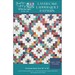 Front cover of pattern partially showing the completed quilt, an array of criss crossing patchwork squares with sawtooth stars in the center.