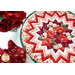 A partial shot of the completed Point of View Folded Star Table Topper. The Topper is staged on a white table with red roses and red cloth napkins.