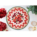 A top down shot of the full table topper staged on a white table with flowers, napkins, and wine glasses, showing symmetry and piecing details. 