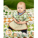 A very sweet baby sitting on top the Little Pathways Quilt in Wee Safari, modeling the toddler bib, demonstrating scale and size.