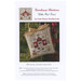 Front of pattern showing the completed small cross stitch ornament staged with holly on the branch of a Christmas tree.
