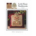 Front of pattern showing the completed cross stitch on a small ornament pillow in front of flowers and leaves