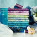 A stack of colorful fabric in shades of purple and blue, with matching spools of thread and decorative elements.