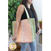 A shot of a model carrying the jelly roll tote, demonstrating the patchwork and size.