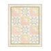 The completed Patchwork Sentiments quilt in white as well as pink, yellow, and green pastels, isolated on a white background.