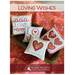 Book cover showing five cross-stitch heart pillows with the title Loving Wishes