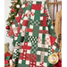 The picnic quilt, artfully draped over a ladder to show dimension and form. The quilt is surrounded by coordinating Christmas decor.