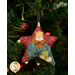 A close up on the ornament featuring a wiseman, showing detail on the crown and his gift.