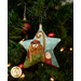 A close up on the ornament featuring the holy mother and father, showing detail on the dimensional mustache and laser cut shepherd's crook.