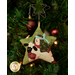 A close up on the ornament featuring the shepherd holding a fluffy sheep.