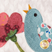 A super close up on the bluebird, showing applique and fabric details.