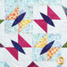 A super close up on one of the floral blocks, demonstrating fabric, piecing, and top quilting details.