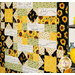 A shot of the quilt from a slight angle, demonstrating fabric colors, piecing, and layout details. Yellow flowers and decor peek into frame from the right side.