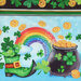 8x8 swatch of border stripe fabric featuring a green boot, a pot of gold, shamrocks, and a rainbow.