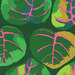 Dark green fabric with large, vibrant green leaves with pink accents