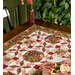 A partial shot of the table runner on a dark wood table, staged with coordinating cloth napkins and decor.