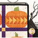 A close up on the upper right hand corner of the project with an oval pumpkin in a flying geese design, demonstrating fabric and piecing details.