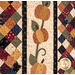 A close up on three laser cut applique pumpkins, showing fabric and stitching details.