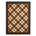 The completed Tennessee Waltz Quilt featuring a geometric pattern in orange, black, and cream fabrics from the Nevermore collection, isolated on a white background.