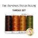 Four spools of thread in brown, orange, cinnamon, and green labeled 