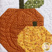 A super close up on one of the pumpkin blocks, demonstrating fabric and top quilting details.