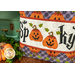 A closer look at the pillow, showing fabric colors and details on the applique jack-o'-lanterns.
