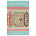 The front of the Little Charmers 5 pattern showing the finished table runners and quilt on a cream paneled background.