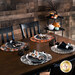 The four completed Oval Placemats colored in gray, orange, and cream fabrics from the Witching Hour collection, staged on a brown table in four place settings under set plates with coordinating Witching Hour napkins, surrounded by coordinating Halloween decor.