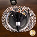 A top down shot of the black cat placemat set with plates and silverware topped by a coordinating Witching Hour cloth napkin.