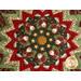 Colorful quilt center featuring a star pattern with Santa Claus figures and stars, with a red, cream, and green border.