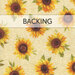 Swatch of a cream fabric with tossed medium sunflowers in golden orange and yellow. A banner at the top reads 