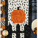 A close up of a pumpkin and black fence in the quilt, demonstrating fabric and top quilting details.