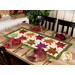 The completed Maple Leaf Runner, colored in rich orange, red, and green fabrics from the Wine Country - Artisan Batiks collection, staged on a rustic wooden table with coordinating tableware, napkins, and wine glasses in the background.