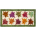 The completed Maple Leaf Runner, colored in rich orange, red, and green fabrics from the Wine Country - Artisan Batiks collection, isolated on a white background. 