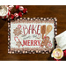 A top-down image of the Bake And Be Merry panel placemat on a wooden table, with fabric napkins, peppermint candy, and a mug of hot cocoa peeking into the corners of the frame.